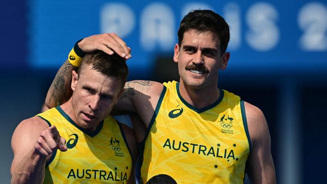 Australia's forward #05 Tom Wickham (L) celebrates scoring his team's in the men's pool B field hockey match between New Zealand and Australia during the Paris 2024 Olympic Games at the Yves-du-Manoir Stadium in Colombes on August 1, 2024. (Photo by Miguel MEDINA / AFP)