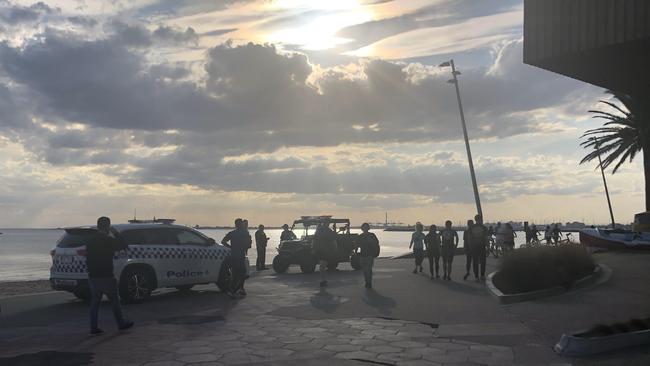 Police arrive at St Kilda beach in Melbourne on Friday evening to clear large groups from congregating on the foreshore.