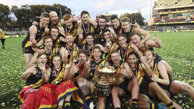 Glenelg players celebrate their 2019 SANFL grand final win over Port Adelaide.