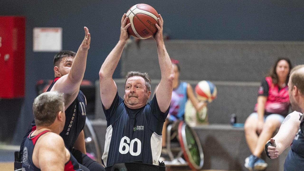 SW Brisbane’s Dave Liddle takes on the SW Toowoomba defence during the Sporting Wheelies Darling Downs Challenge at Clive Berghofer Arena. Picture: Kevin Farmer