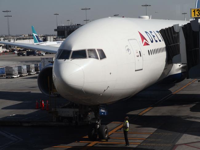 (FILES) In this file photo a Delta Airlines plane sits on the tarmac at Los Angeles International Airport (LAX) in Los Angeles on October 29, 2019. - n the wake of full US approval for the Pfizer/BioNTech anti-Covid vaccine this week, more and more American companies are looking at mandatory vaccinations for employees -- and customers. CVS Health, Chevron, Disney and Goldman Sachs are among the firms who have since told some or all of their workers that inoculations will no longer be optional, requiring proof of shots within a certain time period. (Photo by Daniel SLIM / AFP)