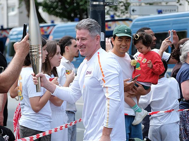 Nine CEO Mike Sneesby carried the Paris Olympics torch in the Olympic torch relay on Monday. Picture: Jacquelin Magnay