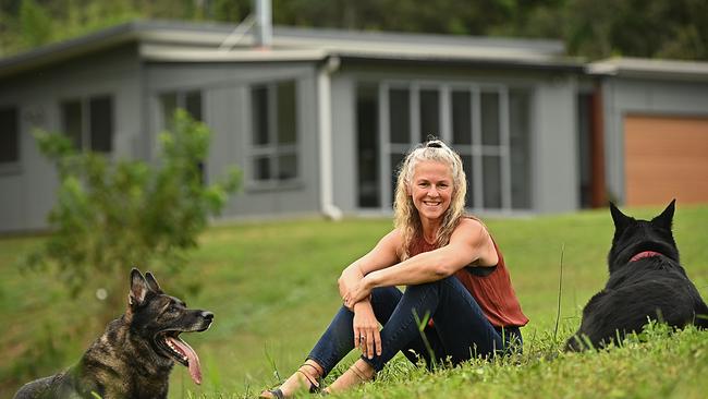 Kellie Ker relaxes with her dogs, Johnny and Peachy at her home in Tallebudgera Valley, west of the Gold Coast. Picture: Lyndon Mechielsen.