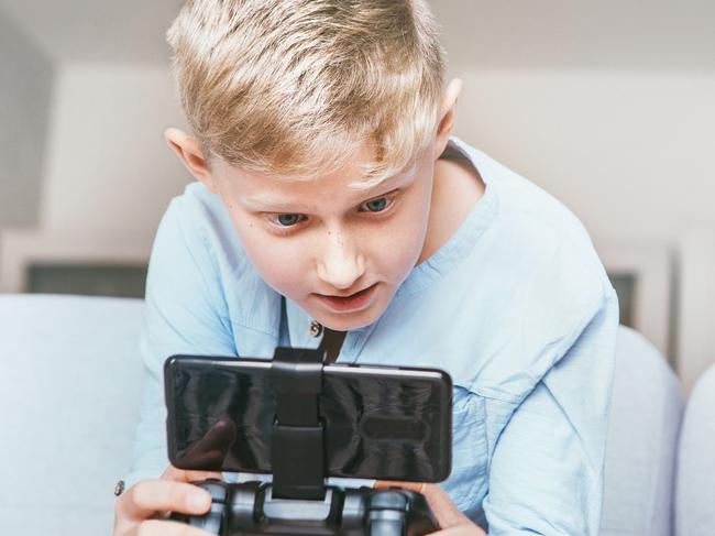 Mother unhappy with teenager son who spent his free time with electronic devices and games. Relationships teenager vs parents concept image. Picture: Istock