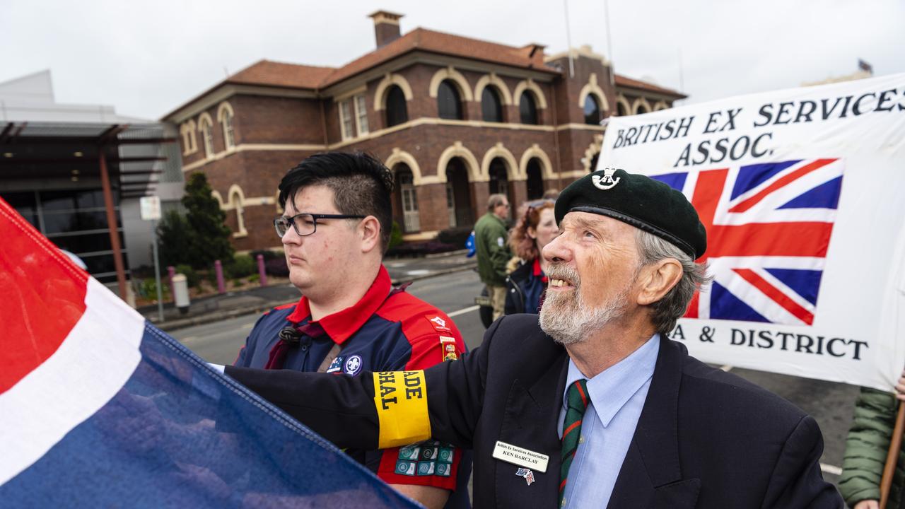 Drayton Rovers member Zac Titcume (left) and parade marshall Ken Barclay check a flag before the Anzac Day morning march, Monday, April 25, 2022. Picture: Kevin Farmer