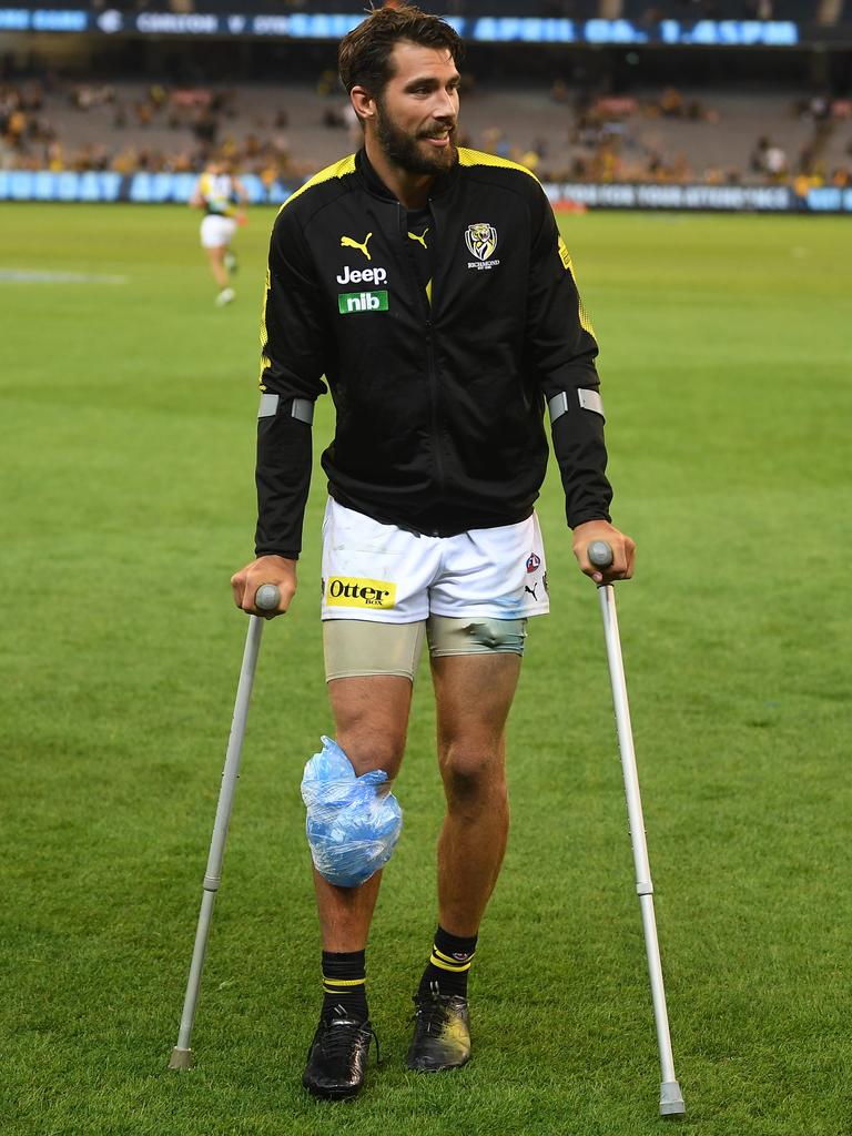 Alex Rance leaves the ground on crutches after Richmond’s win. Picture: Julian Smith. 