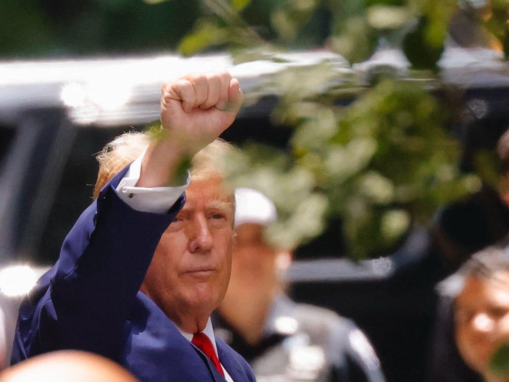 Donald Trump signals to supporters and protesters gathered outside Trump Tower in New York City. Picture: Kena Betancur (AFP)