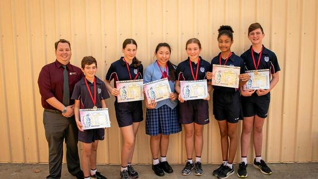 St John&#39;s Humanities students received Honours at the State Opti-Minds Challenge. (From left) Mr Joseph Bortulis, Sean Dawes, Mia Oto, Kiss Cruz, Lilly Kirkbridge, Rosa Nangoye, and Brayden Blaul. Picture: Katarina Silvester