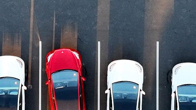 An aerial view shows cars parked at the Tesla Fremont Factory in Fremont, California in 2022. Picture: AFP