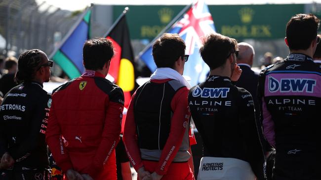 Lewis Hamilton of Great Britain and Mercedes, Carlos Sainz of Spain and Ferrari, Charles Leclerc of Monaco and Ferrari, Pierre Gasly of France and Alpine F1 and Esteban Ocon of France and Alpine F1 look on prior to the Aussie GP.