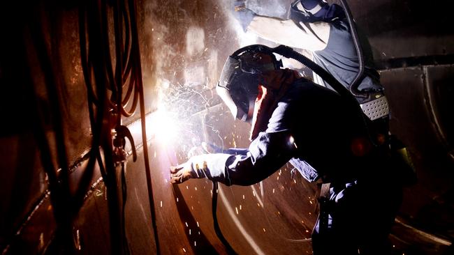 Workers Karl Morris (front) and Paul Hancock welding inside a Precepitation tank at Alcoa Pinjarra Refinery in WA.