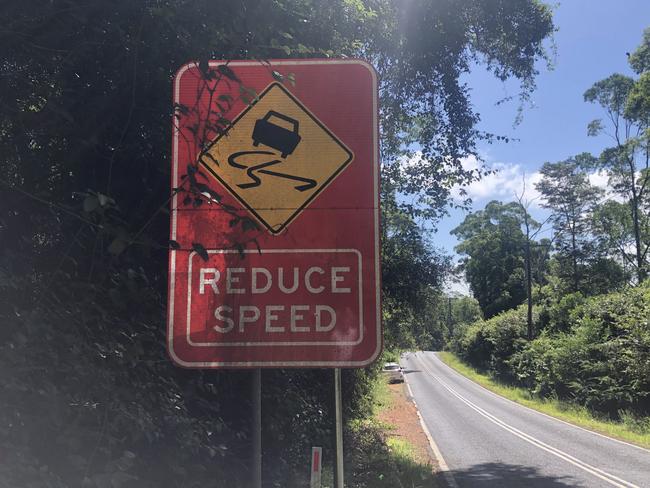 The reduce speed sign with the slippery when wet motif on Fagans Rd, Lisarow, up the road from where young Archie King was killed. Picture: Richard Noone