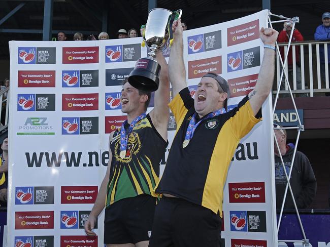 Gavin Artico (right) lifts the 2013 premiership cup as coach of Dromana.