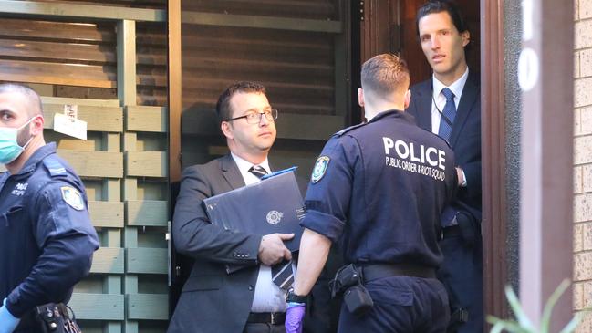 Police during one of the raids. Picture: John Grainger