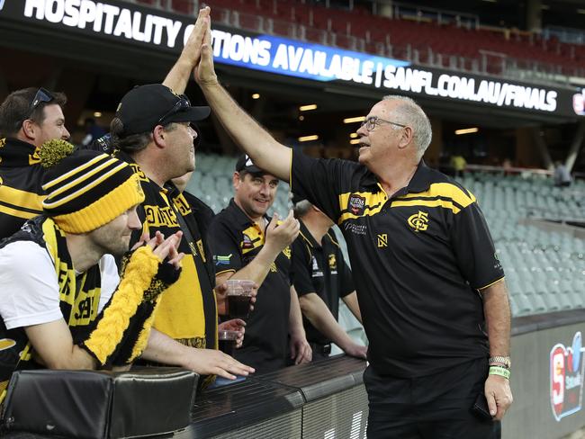 Legendary Glenelg player Peter ‘Super’ Carey high fives fans. Picture: Sarah Reed