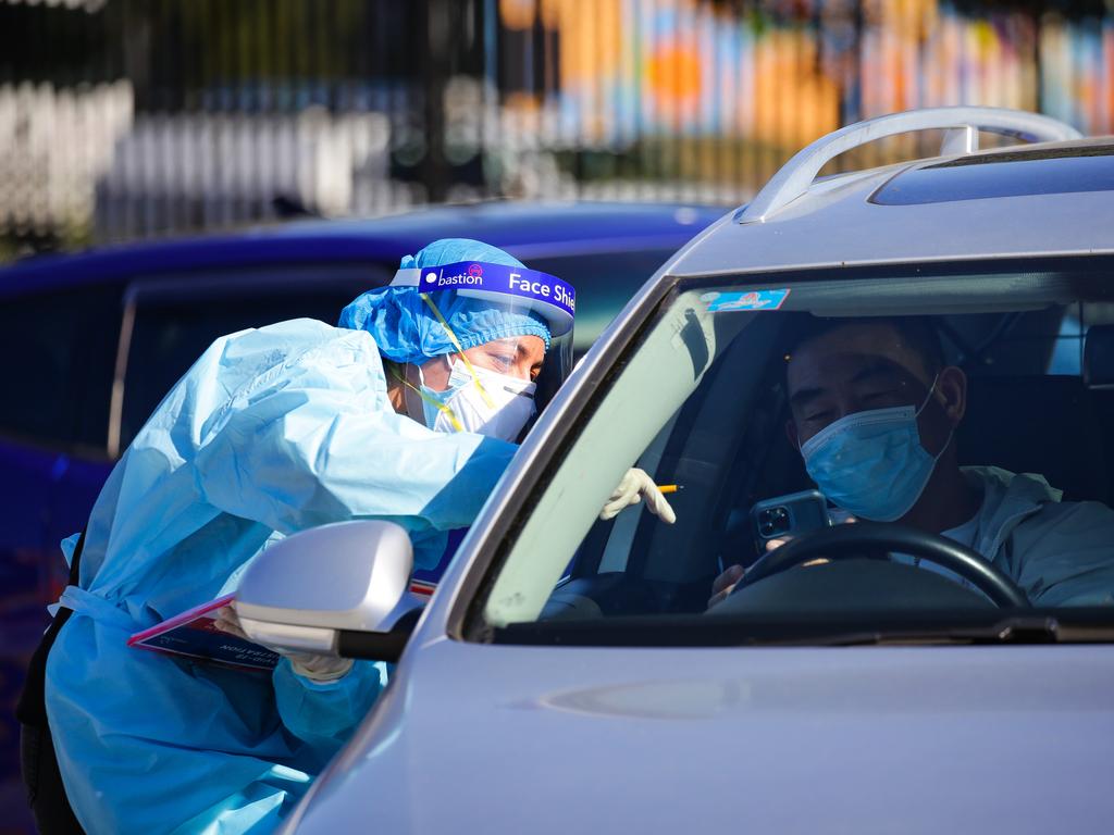 People are seen queuing to get a Covid-19 test at the Auburn Drive-through and Walk-in Clinic in Sydney. Picture: NCA Newswire /Gaye Gerard