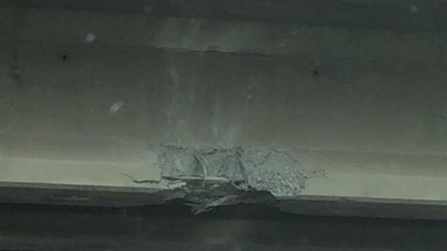 Damage to the Redbank Plains Road bridge after it was struck by a truck carrying an excavator. The first stage of repair work has begun on the busy Cunningham Hwy overpass.