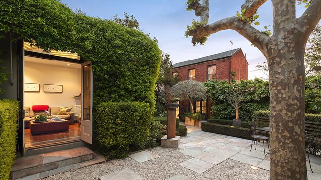 The residence reflects the French-influenced architecture of the time with its bell-shaped roof and colonnaded veranda.