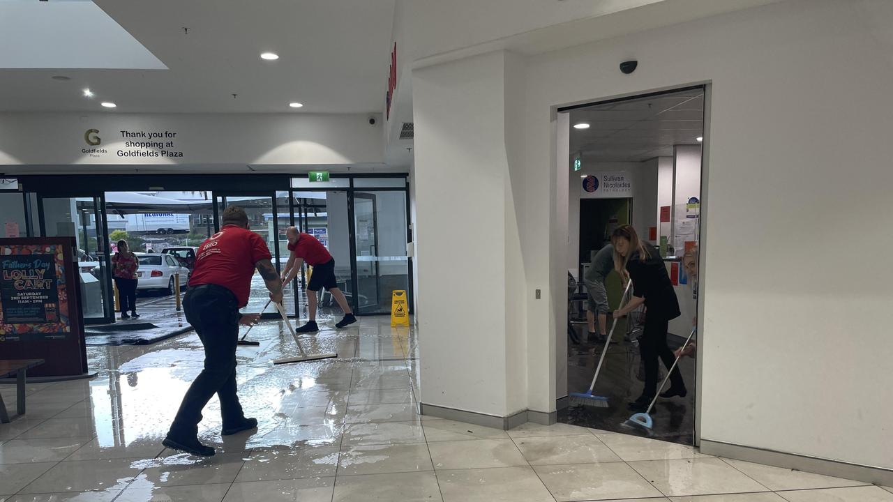 Staff clean up after Gympie hit by a big downpour and hail on August 29, 2023.