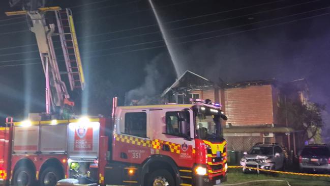 Blaze takes hold of a Bonnells Bay home, in Lake Macquarie, on January 30th after a nearby caravan caught alight. Around 30 firefighters fought to contain the blaze. Credit: NSW Fire and Rescue