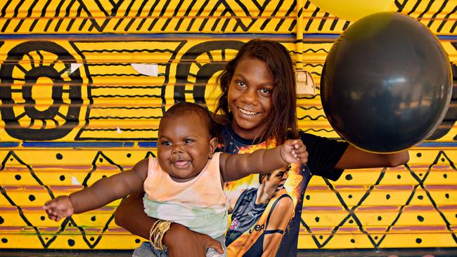 Maria Rioli, with 5 month old nephew Latrell Rioli in the small community of Pirlangimpi which has produced 3 Norm Smith medallists.