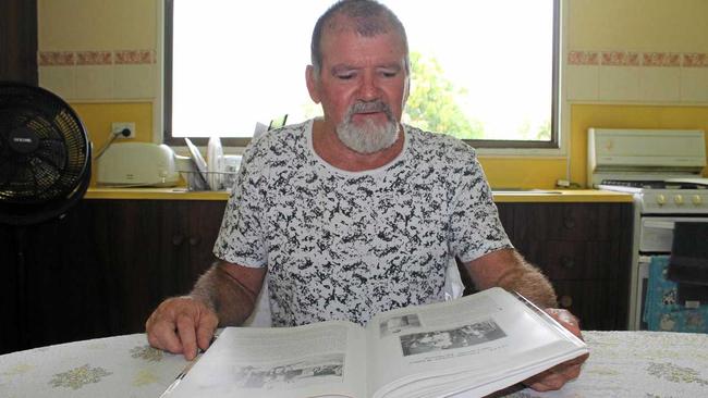 FAMILY STORY: Greg Ellul at his Habana home with a family history book. Mr Ellul says his dad, Joe Ellul, and his grandfather, Guiseppi Ellul, visited the Riverview Hotel (later the Leichhardt Hotel) to see the skin of the 32 foot (9.7m) crocodile when Joe was a boy. Picture: Luke Mortimer