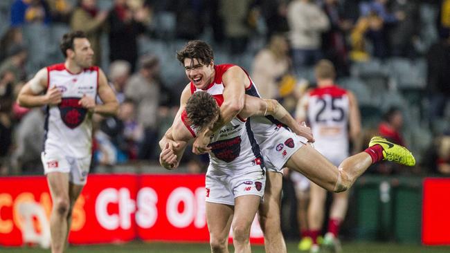 Christian Petracca hugs a Melbourne teammate as the Dees celebrate their win out west. Picture: AAP