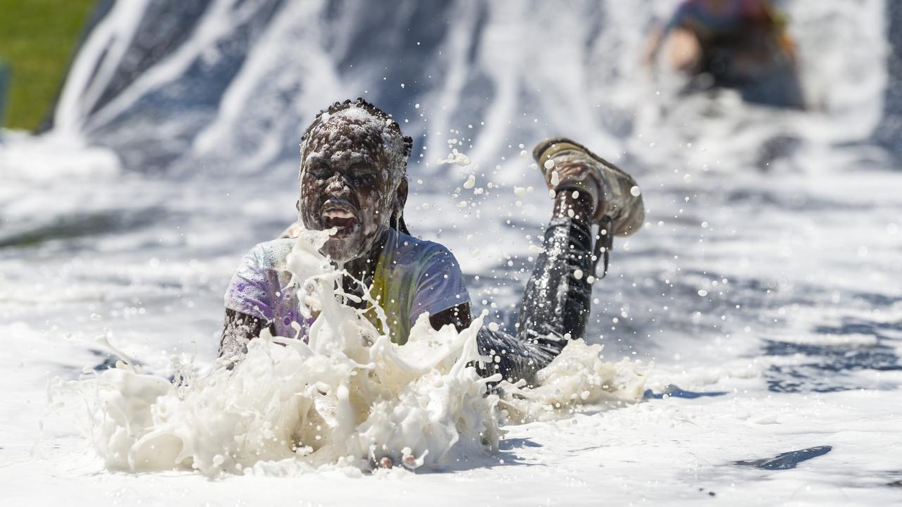 Ahou Dau on the slip'n slide as part of Darling Downs Christian School colour fun run, Friday, October 30, 2020. Picture: Kevin Farmer