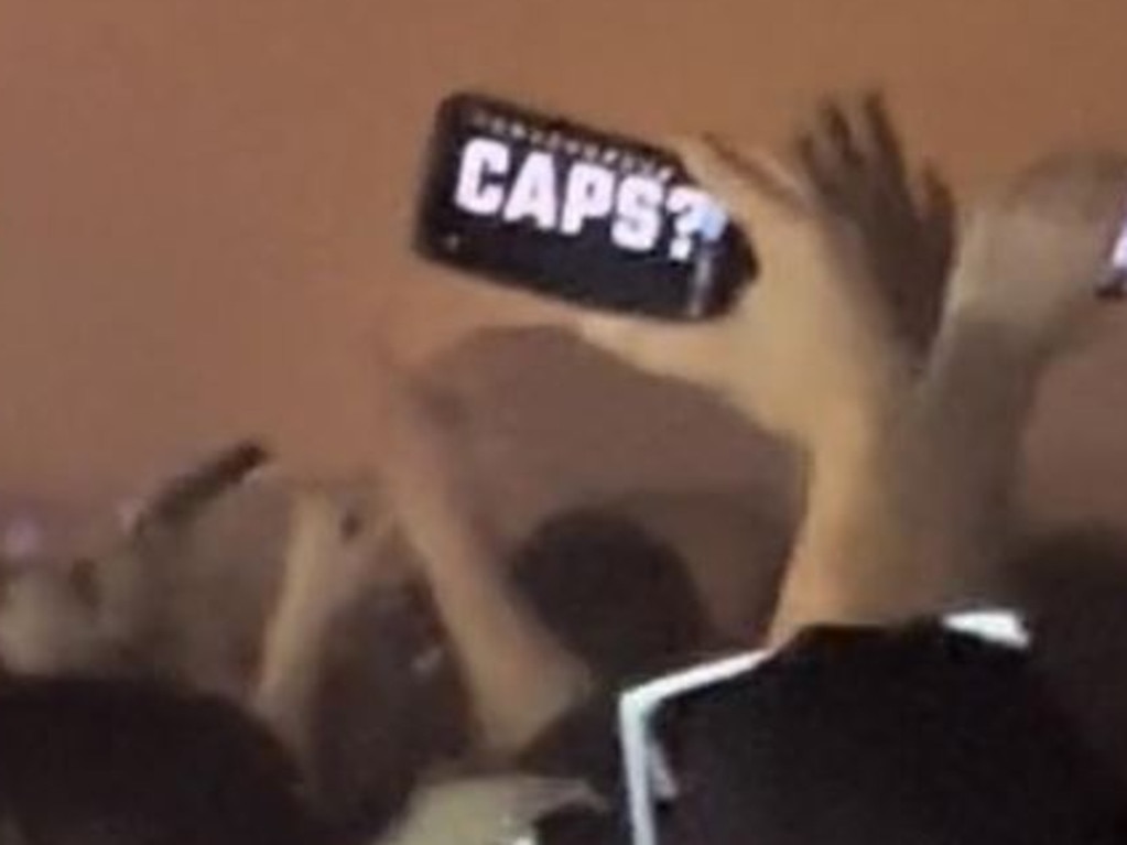 Footage shows a partygoer holding up a phone with the word ‘CAPS?’. Picture: Social media