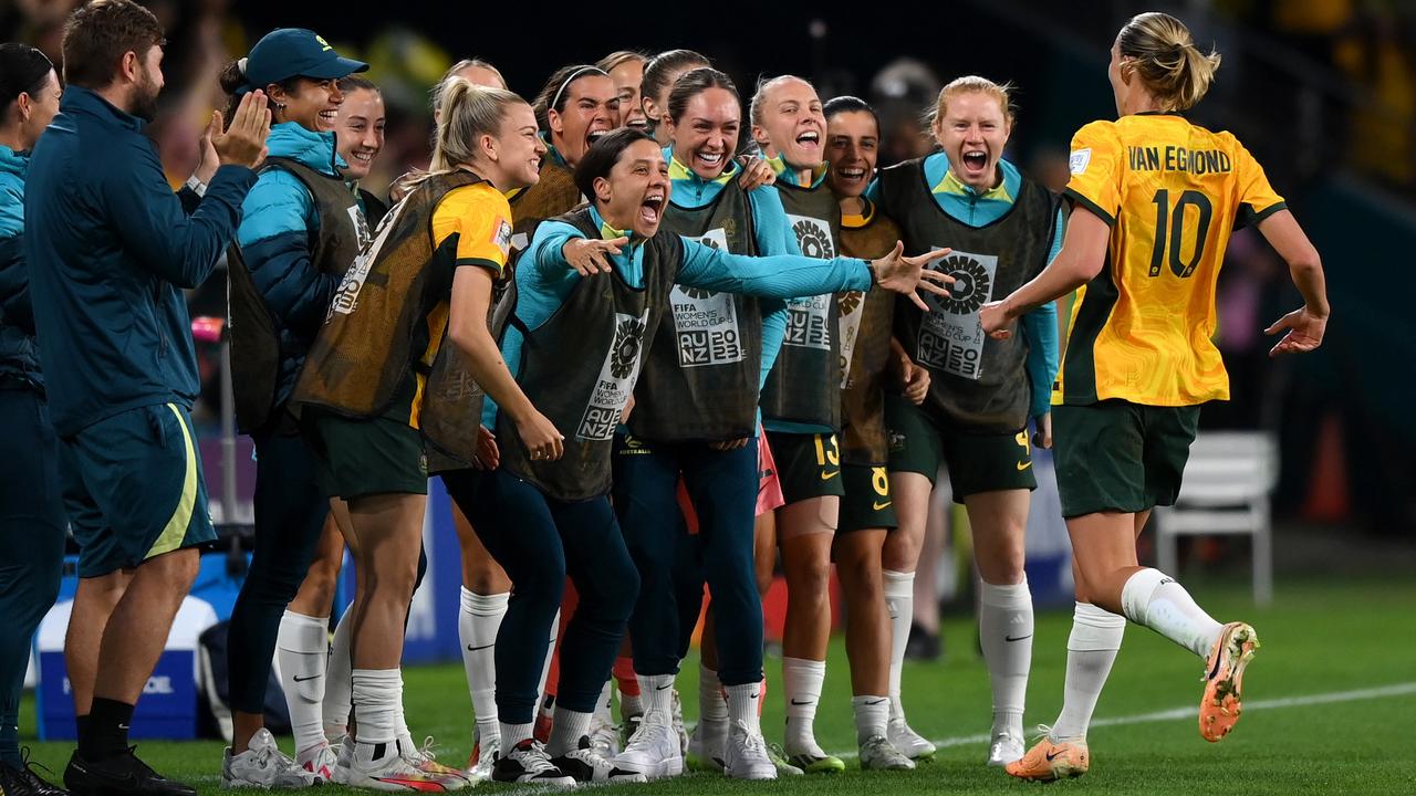 Touchline joy as Emily Van-Egmond runs to Sam Kerr and other substitutes after scoring her team's first goal against Nigeria at Brisbane Stadium. Picture: Justin Setterfield/Getty Images