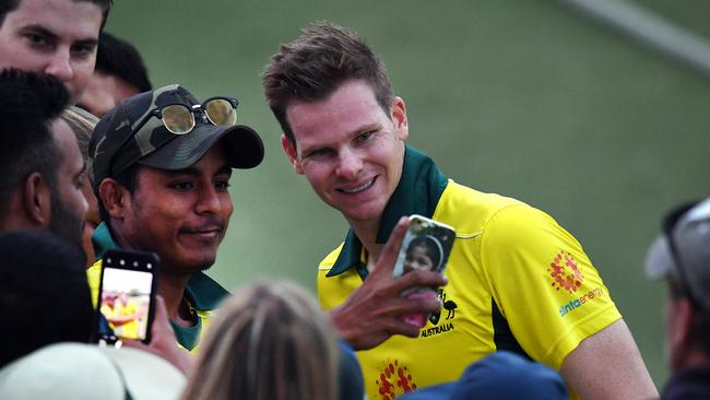 Steve Smith poses for a photo with a fan. Picture: AAP