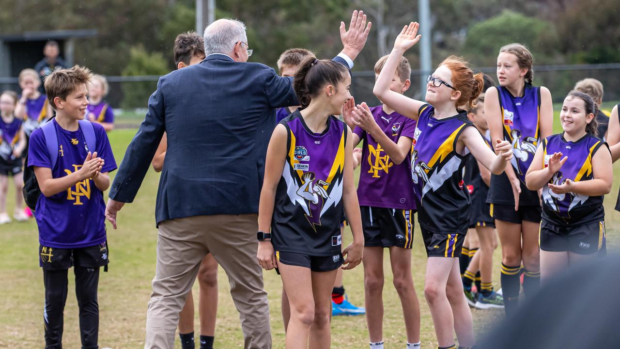 He high fives with the local kids. Picture: Jason Edwards