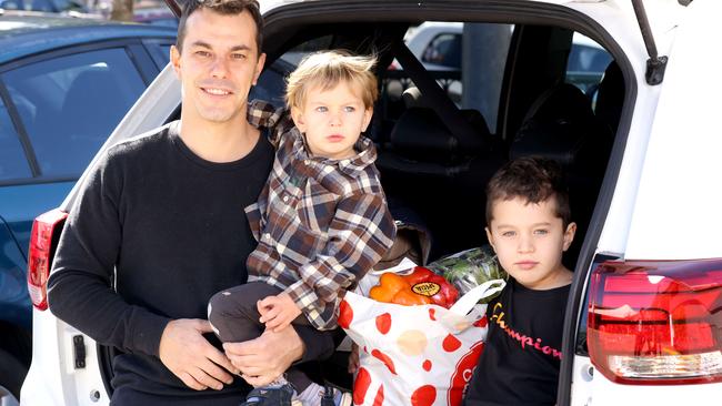 Valentino Ronsisvalle with Diego, 2, and Eduardo, 6, after a trip to the shops to get groceries. Picture: Steve Pohlner