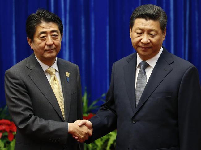 China’s President Xi Jinping (right) shakes hands with Japan’s Prime Minister Shinzo Abe at the Great Hall of the People on the sidelines of the Asia-Pacific Economic Cooperation (APEC) Summit in Beijing.