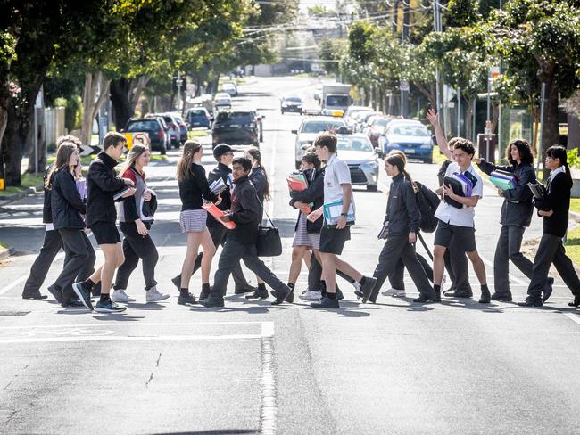 Glen Eira College students cross the road outside their school. Picture: Jake Nowakowski