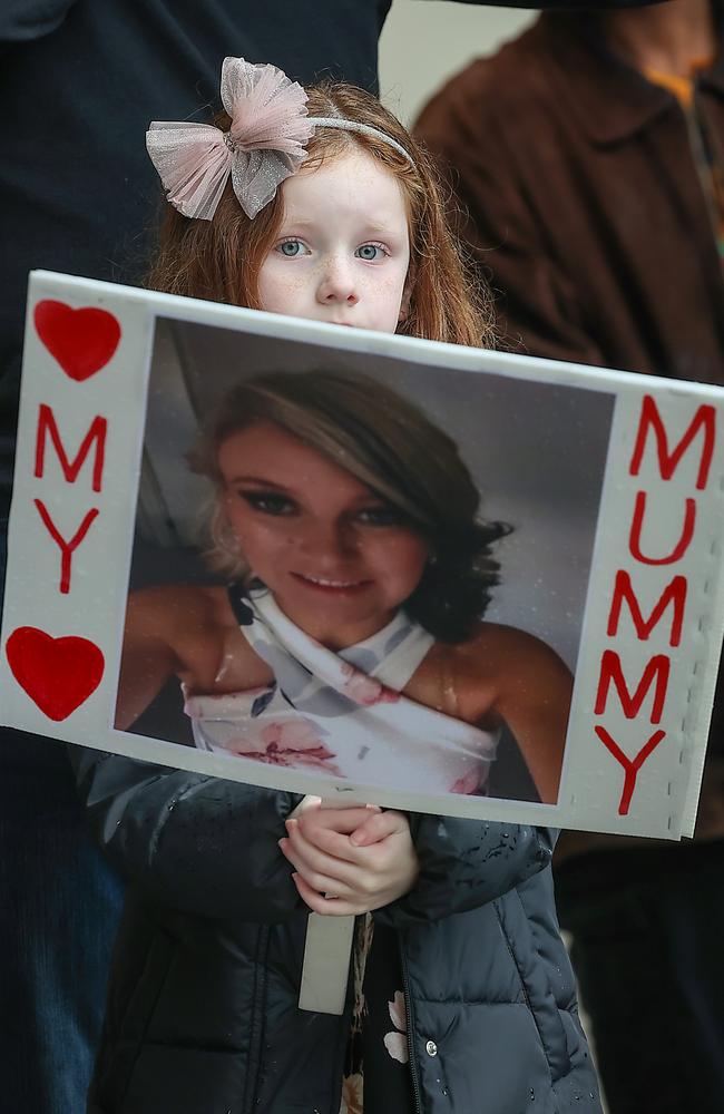 The daughter of murder victim Katie Haley holds a picture of her mother during the No More Rally into violence against women. Picture: NewsWire/Ian Currie