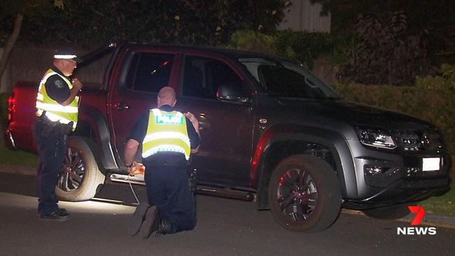 Major Crash officers inspecting the dark grey Amarok V6 W-series ute after the crash Picture: 7 NEWS