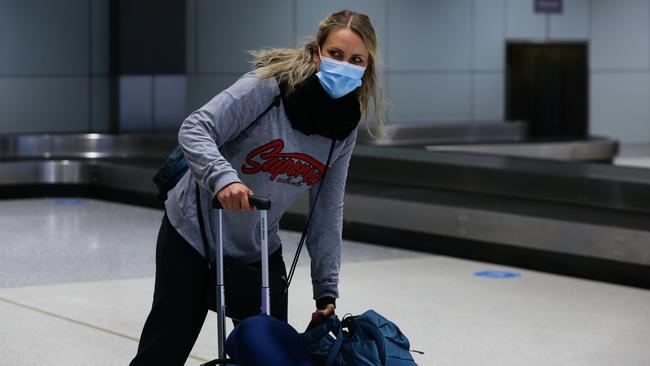 A passenger off the QF Flight from Albury arrives at Sydney Domestic Airport on Friday. Picture: Daily Telegraph/Gaye Gerard