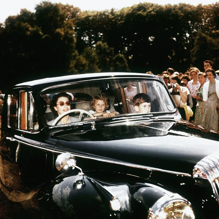 1957: Queen Elizabeth II driving her children Prince Charles and Princess Anne at Windsor, watched by a group of onlookers. Picture: Hulton-Deutsch Collection/Corbis via Getty Images