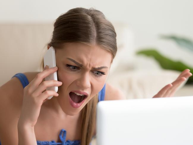 Angry dissatisfied young woman calling customer support or mobile banking, displeased client complaining about bad service, arguing on phone, having conflict during telephone conversation at home