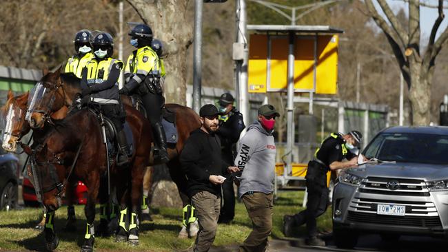 Police question protesters along St Kilda Road in Melbourne on Saturday. Picture: NCA NewsWire / Daniel Pockett