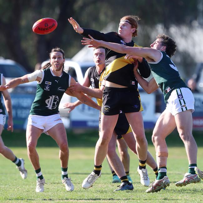 Rochester’s Mitch Cricelli fends off Echuca’s Liam Tenace.