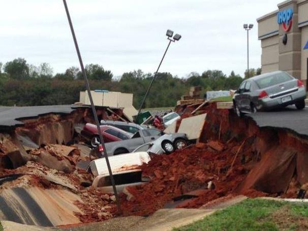 Must have been hungry ... At least 15 cars were swallowed as a sinkhole open up at a new restaurant in Meridian, Mississippi. Picture: WLBT 3 / Facebook