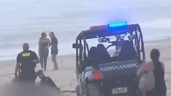 Emergency workers on the beach after a body was found at Main Beach. Picture: Channel 9.