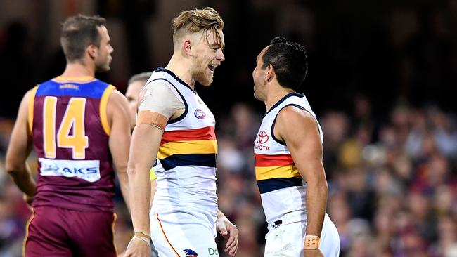 Hugh Greenwood of the Crows celebrates with Eddie Betts after kicking a goal during the round 18 AFL match between the Brisbane Lions and the Adelaide Crows at The Gabba. Picture: Getty Images