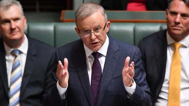 Anthony Albanese delivers his budget reply speech at Parliament House in Canberra on Thursday night, as Tony Burke, left, and Richard Marles listen. Picture Getty Images