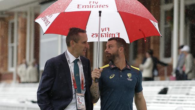 Matthew Wade with Australian Media Manager Brian Murgatroyd look on as rain delays the start of play during day one. Picture: Getty Images