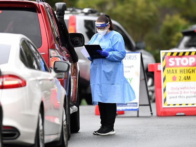 BRISBANE, AUSTRALIA - NewsWire Photos - JULY 1, 2021.A health worker processes arrivals at a COVID-19 drive-through testing station at Murarrie in Brisbane's east. Queensland has gone into a 3-day lockdown due to a recent Covid outbreak.Picture: NCA NewsWire / Dan Peled