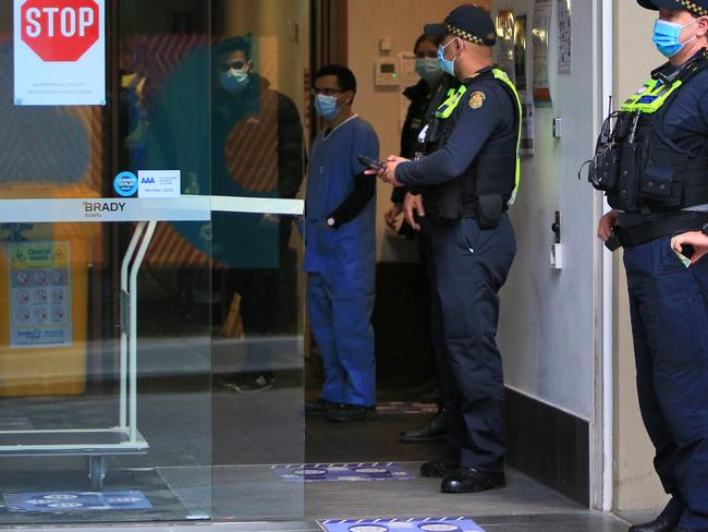 Police and staff at the Brady Hotel in Little La Trobe Street which is serving as one of the hotel quarantines. Picture: Aaron Francis