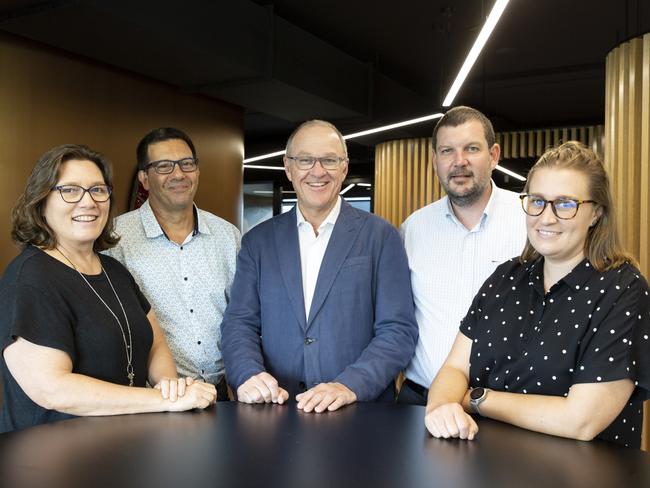 PwC Australia team members Jenny Scott, Michael McGregor, Tom Seymour, Sean O’Meara and Lauren McNamara standing in the new Darwin office. Picture: Floss Adams